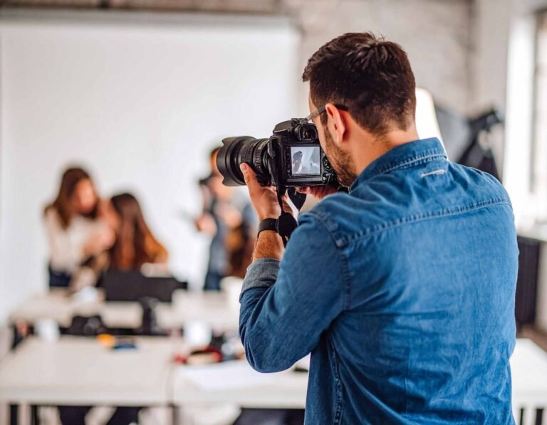 A photographer conducts a school workshop on photography, engaging students in practical learning.