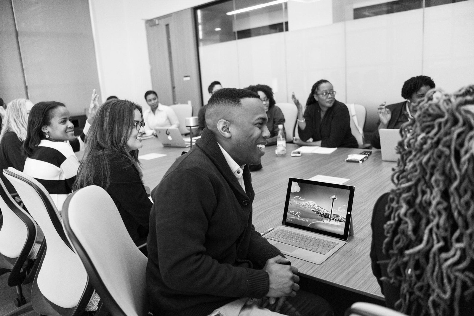 conference room photograph of people smiling and laughing